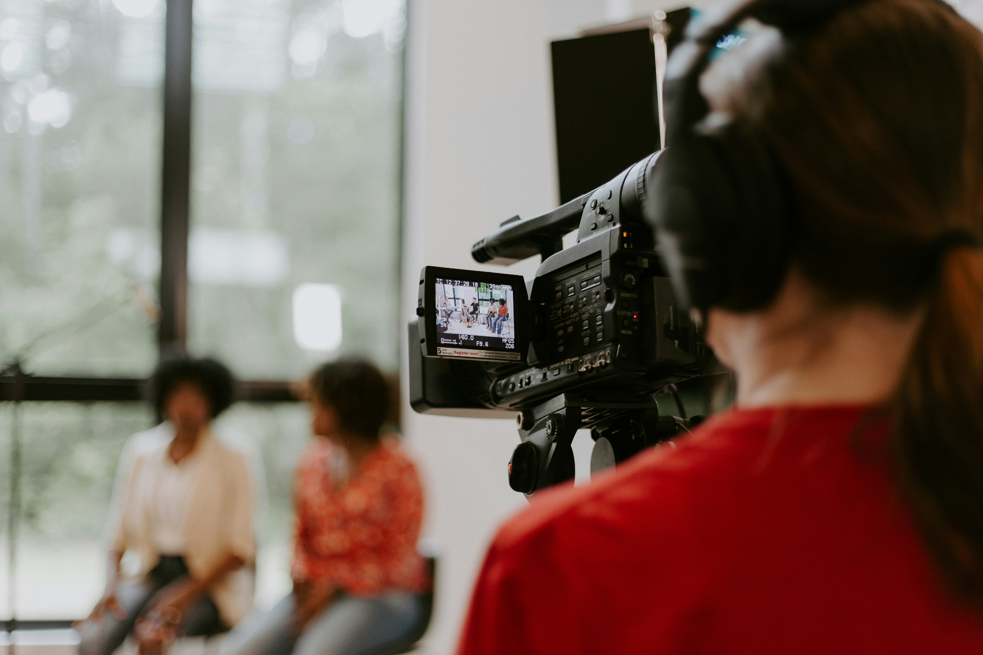 Behind the camera at a content shoot with two founders in frame